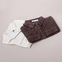 Load image into Gallery viewer, Baby white and brown corduroy jumpsuits laying folded in half on top of one another