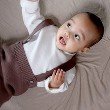 Load image into Gallery viewer, Baby laying wearing white mockneck long sleeve shirt with brown cotton knit jumper