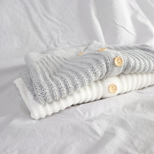 Load image into Gallery viewer, Baby grey and white long sleeved knit rompers folded laying on top of each other showing buttons