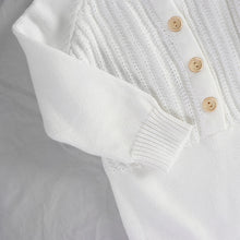 Load image into Gallery viewer, The sleeve of white knit long sleeved romper showing ribbed wrist cuff
