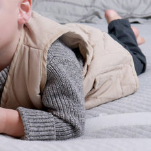 Load image into Gallery viewer, Toddler laying on stomach wearing grey sweater and beige padded vest and grey pants