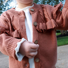 Load image into Gallery viewer, Toddler standing wearing white mockneck cotton long sleeved shirt and brown flutter cardigan