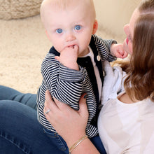Load image into Gallery viewer, Baby sitting on moms lap with fingers in mouth wearing white shirt and navy striped cotton cardigan