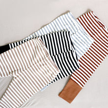 Load image into Gallery viewer, Four pairs of striped cotton baby leggings in the colors tan, black, light grey and brown.