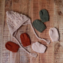 Load image into Gallery viewer, baby latte colored bonnet and cinnamon, latte, and olive colored baby knit mittens laying on brown background