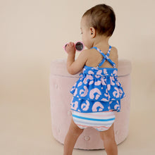 Load image into Gallery viewer, Toddler standing facing the wall holding pink sunglasses wearing pink and blue cheetah tankini
