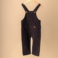 Load image into Gallery viewer, dark denim jumpsuit hanging on wooden hanger