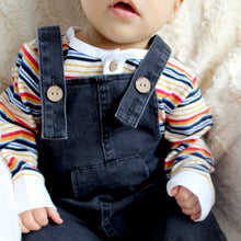 Load image into Gallery viewer, front of dark denim overalls and multi colored striped shirt underneath