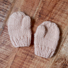 Load image into Gallery viewer, latte colored baby hand knit mittens on brown background