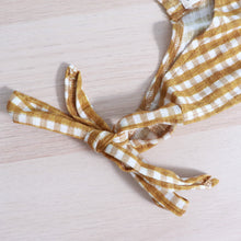 Load image into Gallery viewer, hand tied strap in bow of gold gingham tiered toddler dress