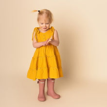 Load image into Gallery viewer, toddler standing with hands together wearing yellow gold gingham strapless tiered dress and pink rainboots