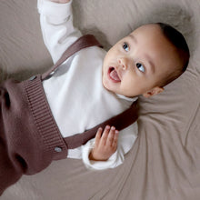 Load image into Gallery viewer, Baby laying wearing white mockneck long sleeve shirt with brown cotton knit jumper
