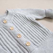 Load image into Gallery viewer, Top of baby grey long sleeved knit romper showing buttons and ribbed cuff at end of sleeve
