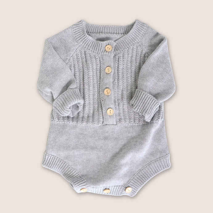 Baby grey long sleeved knit romper with four buttons in the center and three buttons at crotch opening 