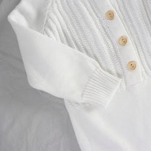 Load image into Gallery viewer, The sleeve of white knit long sleeved romper showing ribbed wrist cuff

