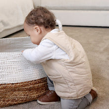 Load image into Gallery viewer, Baby playing wearing white long sleeved shirt with beige padded vest and grey pants and brown boots
