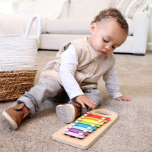 Load image into Gallery viewer, Baby sitting playing wearing white long sleeved shirt and beige padded vest with grey pants and brown boots

