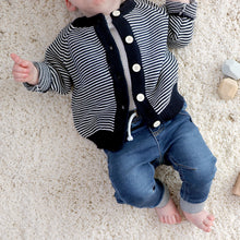 Load image into Gallery viewer, Baby laying wearing blue denim jeans and white shirt underneath navy striped cotton cardigan 
