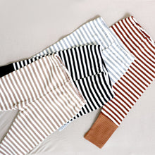 Load image into Gallery viewer, Four pairs of striped cotton baby leggings in the colors tan, black, light grey and brown.
