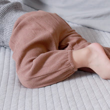 Load image into Gallery viewer, Baby laying wearing grey sweater and brown waffle pants
