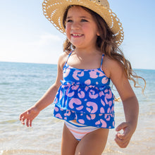 Load image into Gallery viewer, Child standing on the beach with a hat wearing a pink and blue cheetah tankini
