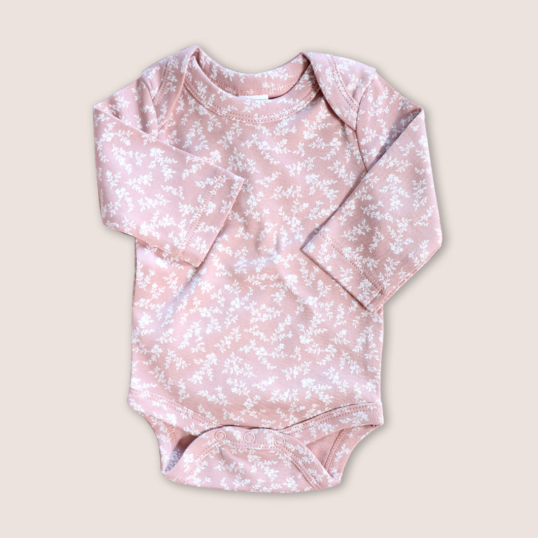 pink baby onesie with white floral design