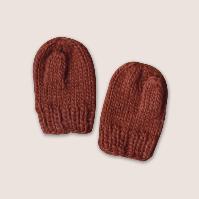 cinnamon colored baby hand knit mittens on white background