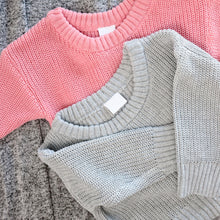 Load image into Gallery viewer, Grey knitted baby sweater laying on top of pink knitted baby sweater
