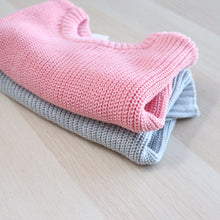 Load image into Gallery viewer, Pink knitted sweater folded on top of folded grey knitted baby sweater
