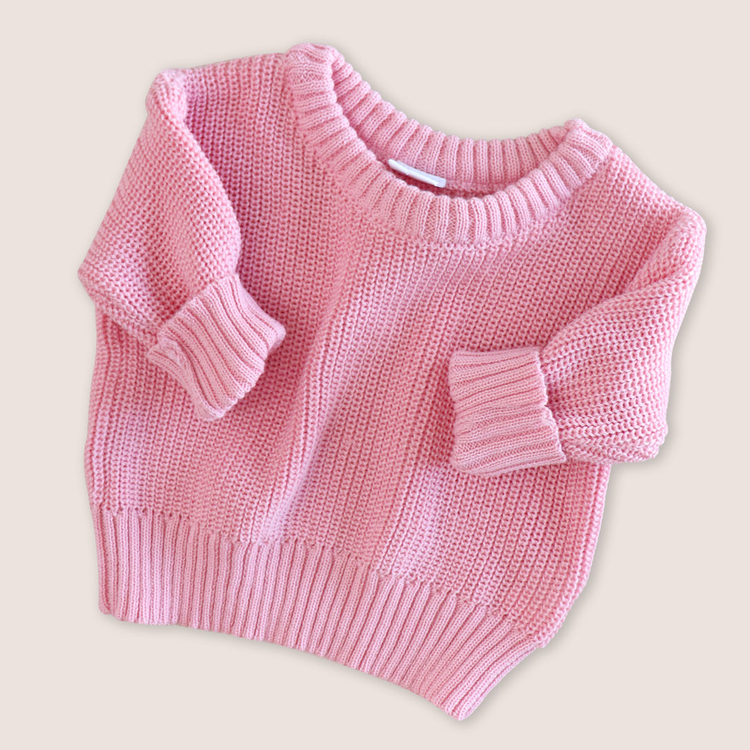 pink knitted baby sweater with ribbed sleeves
