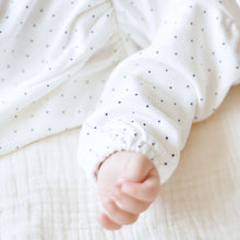 Load image into Gallery viewer, babys arm and hand shown wearing white long sleeve shirt with navy blue polka dots
