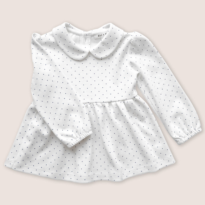 white baby tunic with navy blue polka dots and peter pan collar 
