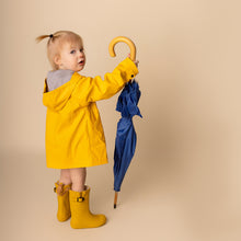 Load image into Gallery viewer, toddler standing holding blue umbrella wearing yellow rain jacket and yellow rain boots 
