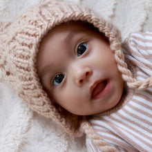 Load image into Gallery viewer, baby&#39;s face wearing latte colored knit bonnet
