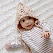 Load image into Gallery viewer, baby laying on white blanket wearing latte colored knit bonnet and white and tan striped onesie
